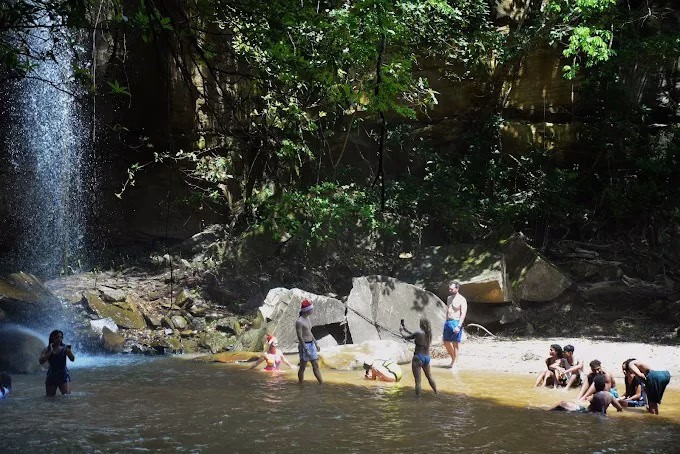 Tourists walking through forest trail to Sheldrick Waterfalls in Shimba Hills, Kenya