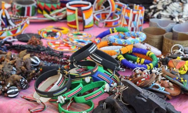 Artisan carving wood at Akamba Handicraft Centre