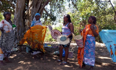 Visitors walking through the traditional Funzi Island village on a cultural tour from the Kenya coast