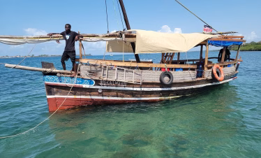 Traditional Swahili dhow sailing to Wasini Island for a marine safari from Diani Beach