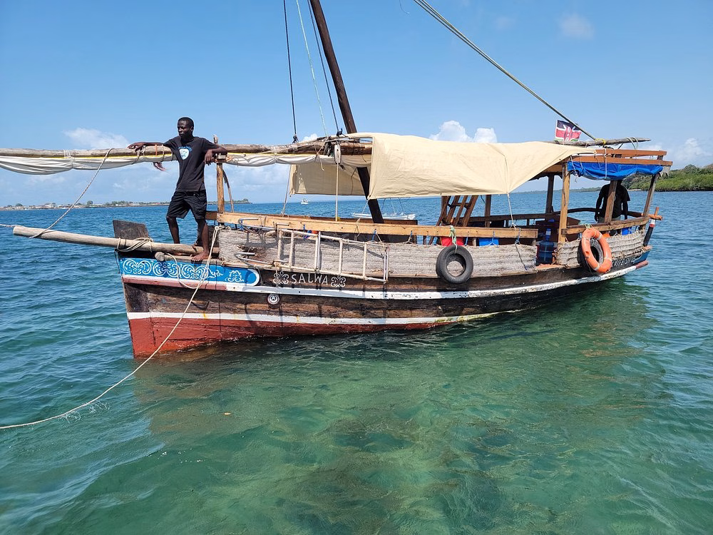 Traditional Swahili dhow sailing to Wasini Island for a marine safari from Diani Beach