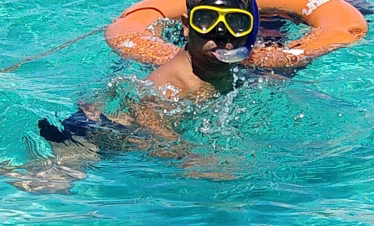 Snorkeler exploring coral reefs at Kisite Marine Park during a Wasini Island day trip from Mombasa