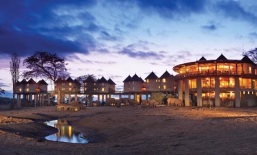 Night view of Salt Lick Safari Lodge lit up in the African wilderness