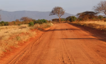 Panoramic view of Tsavo East National Park with red earth and open savannah