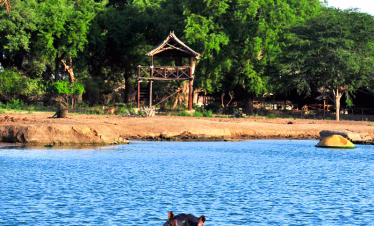 Night view of Satao Camp surrounded by nature in Tsavo East National Park