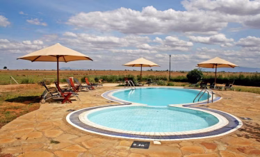 Ashnil Aruba Lodge swimming pool area with savannah views in Tsavo East National Park