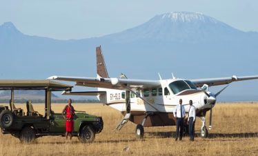Plane at Amboseli National Park plains with Mount Kilimanjaro in the background during a 3-day flying safari from Diani Beach or Mombasa