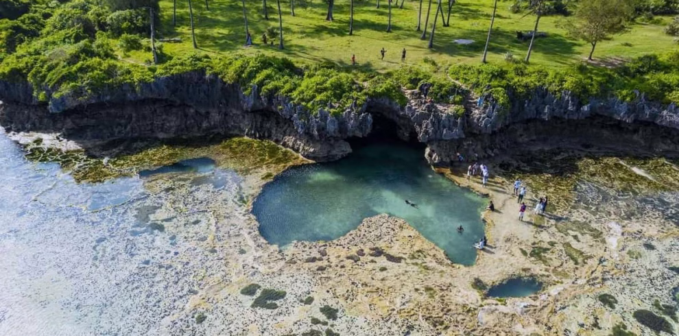 Aerial view of the African Pool in Diani Beach, Kenya -natural rock pool shaped like Africa surrounded by turquoise ocean water