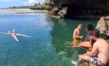 Tourists swimming in the African Pool, Diani Beach - a hidden natural attraction on Kenya’s south coast.